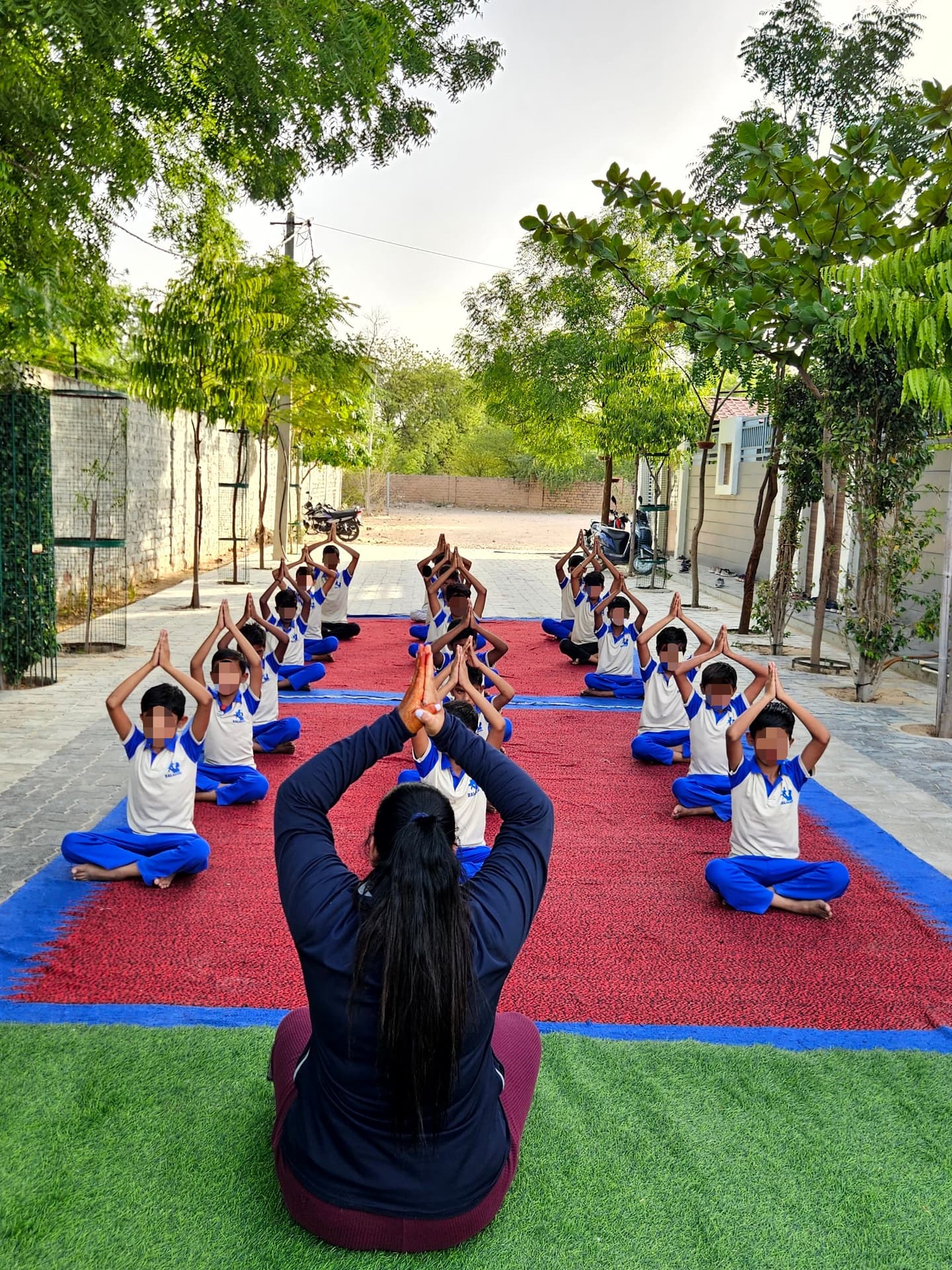 Children doing yoga on turf